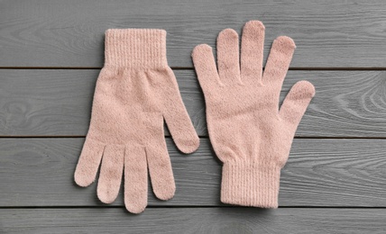 Stylish gloves on grey wooden background, flat lay