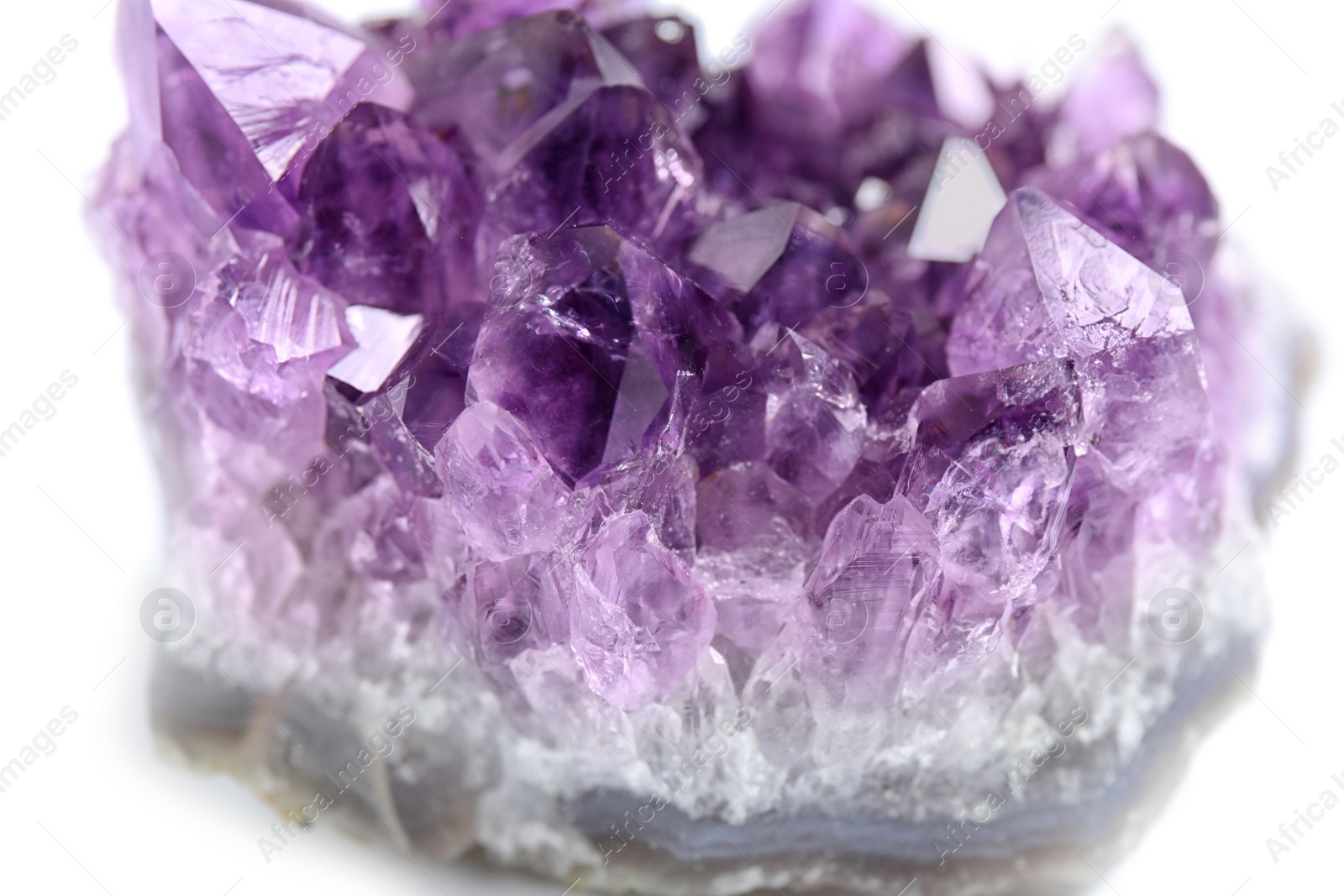 Photo of Beautiful purple amethyst gemstone on white background, closeup