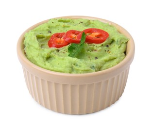 Photo of Bowl of delicious guacamole with chili pepper isolated on white