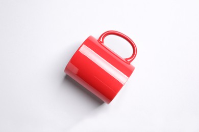 Photo of One red ceramic mug on light background, top view