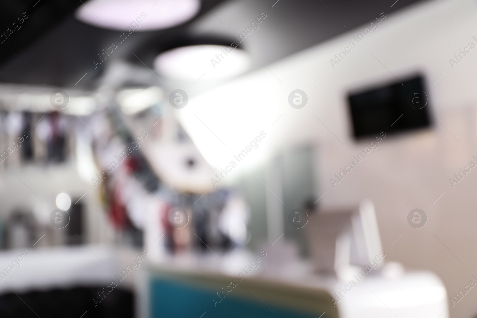 Photo of Blurred view of dry-cleaner's interior with garment conveyor