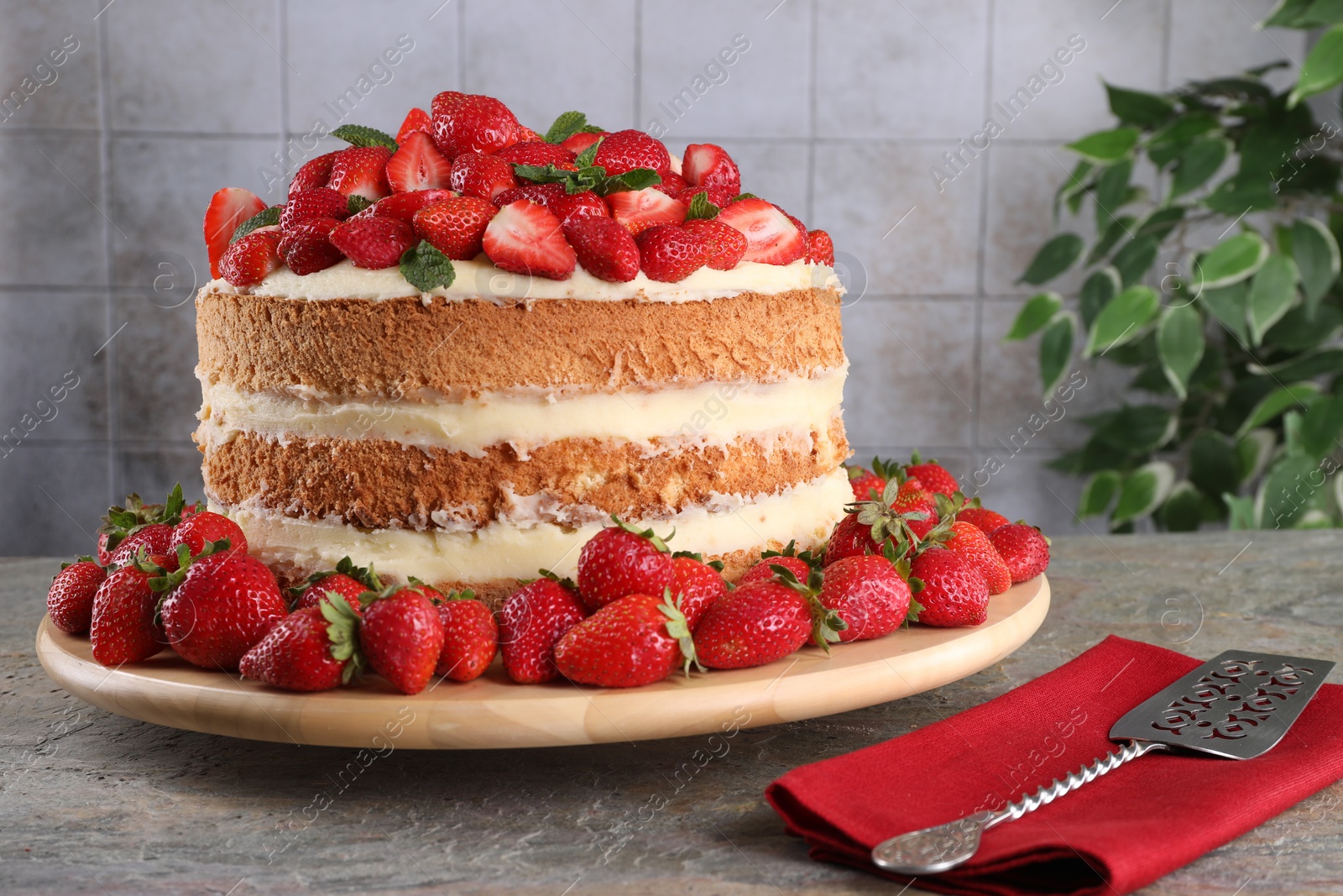 Photo of Tasty cake with fresh strawberries and mint served on gray table
