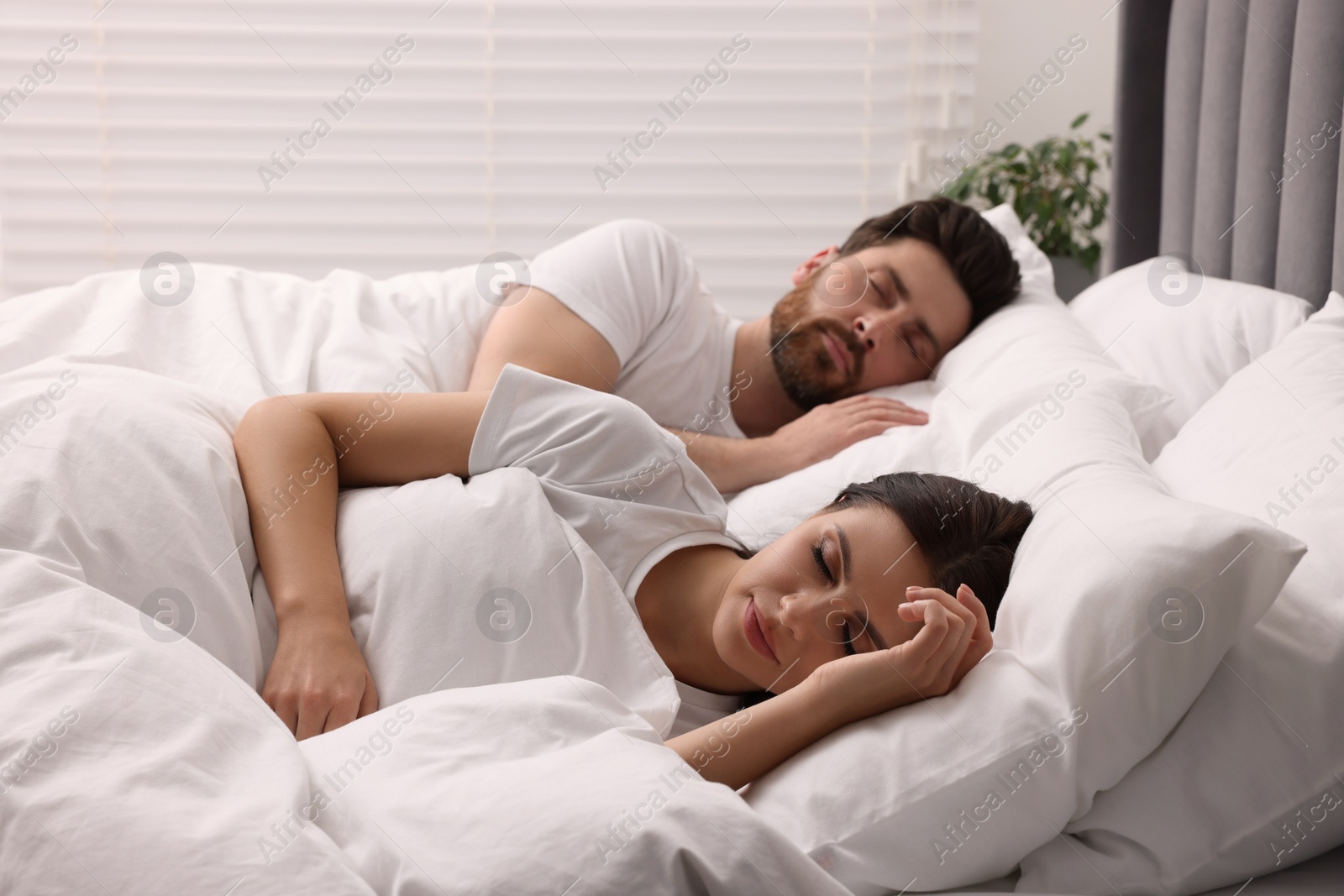 Photo of Lovely couple sleeping together in bed at home