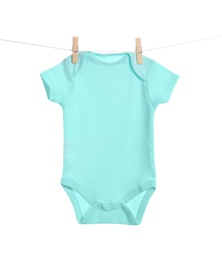 Photo of Baby onesie hanging on clothes line against white background. Laundry day