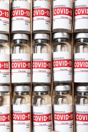 Photo of Glass vials with COVID-19 vaccine in package, top view