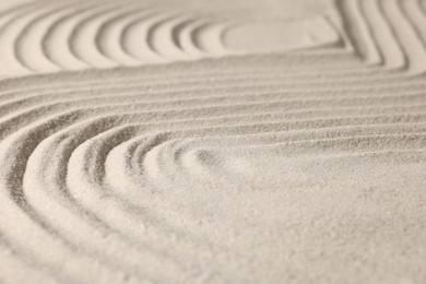 Beautiful lines drawn on sand, closeup. Zen garden