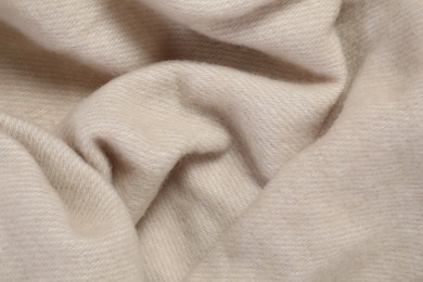 Texture of beige blanket as background, top view