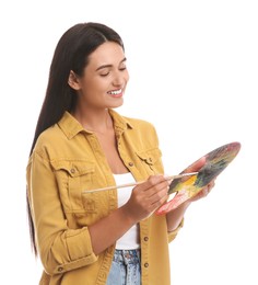 Young woman drawing with brush on white background