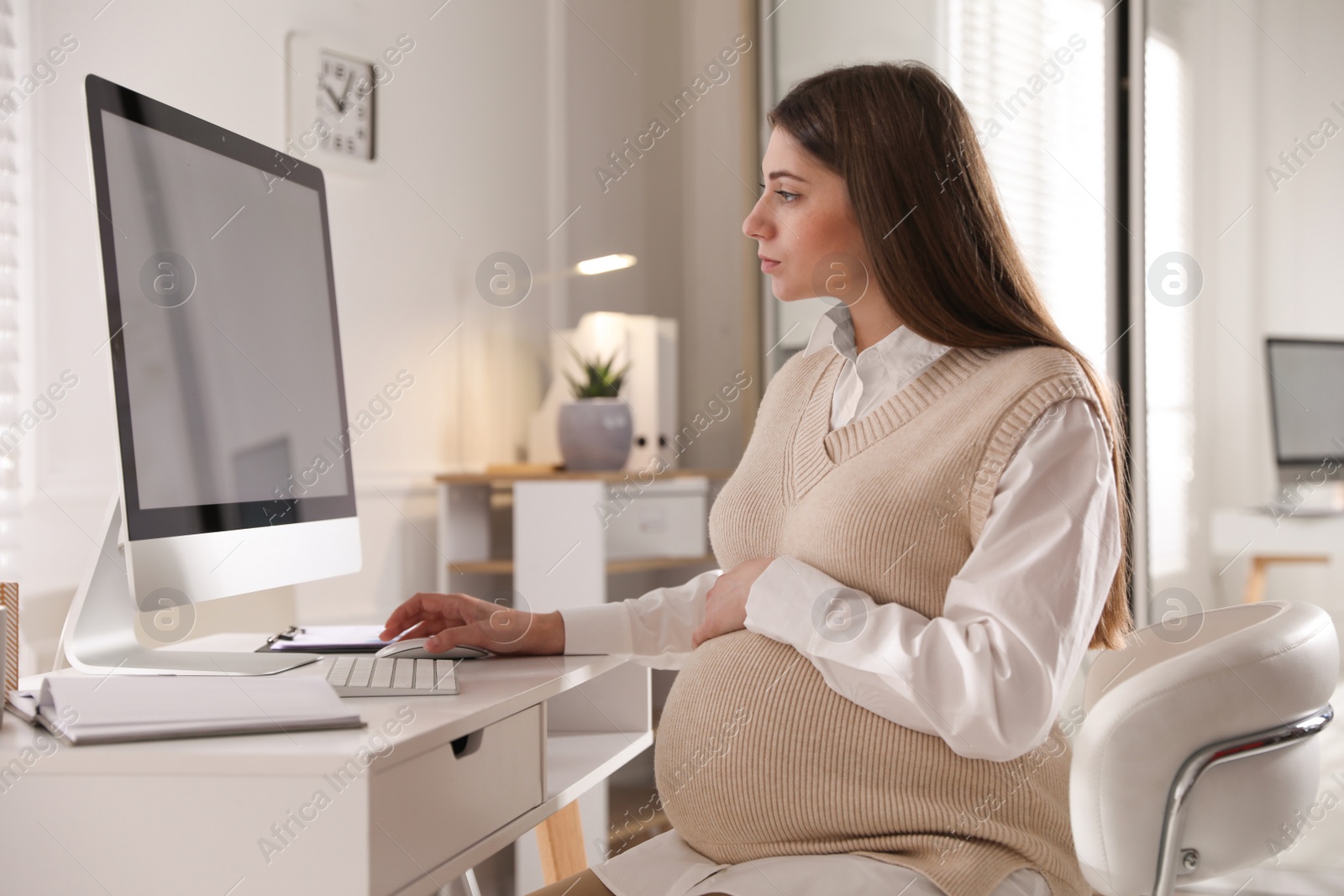 Photo of Pregnant woman working at home. Maternity leave