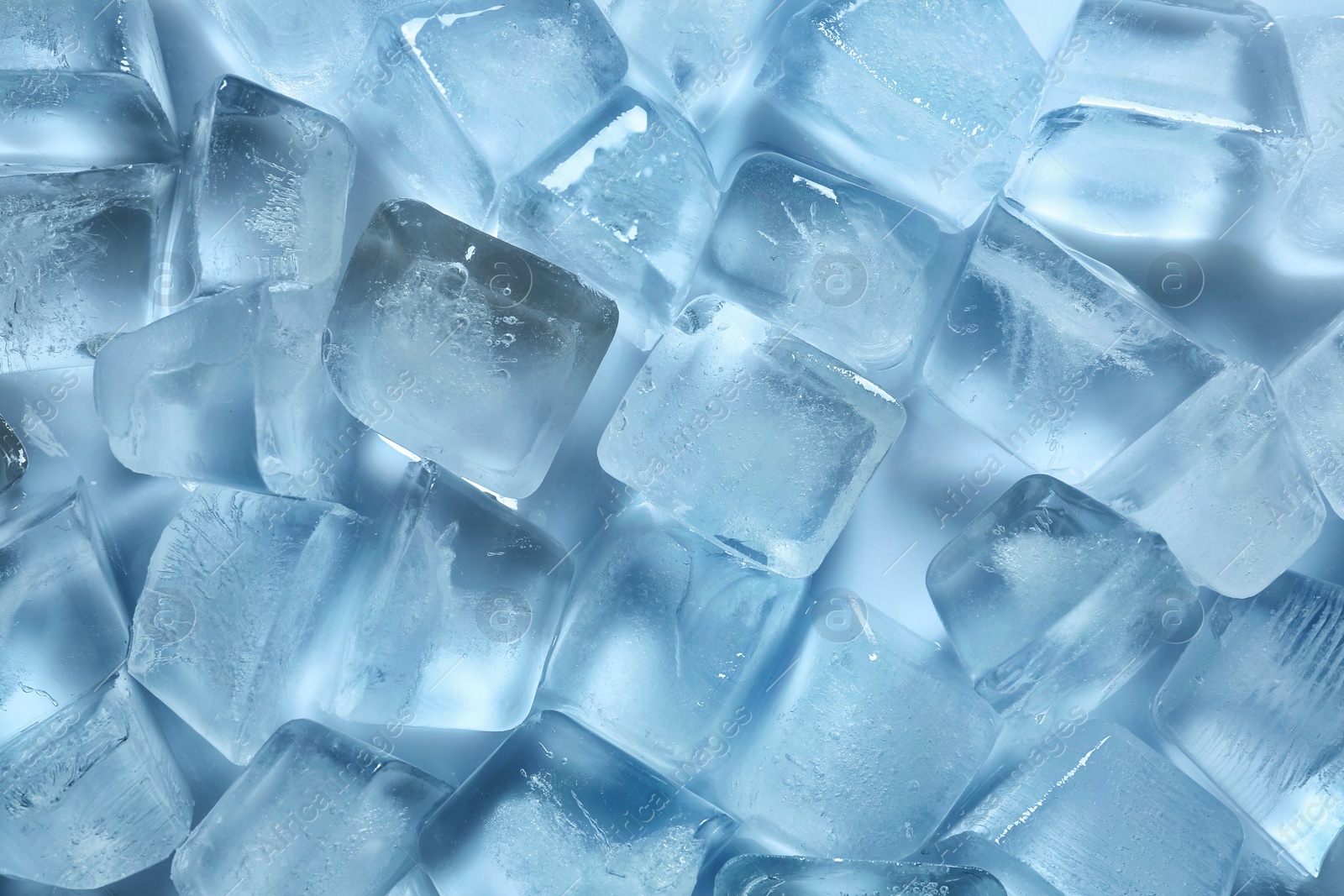 Photo of Many ice cubes on color background, top view