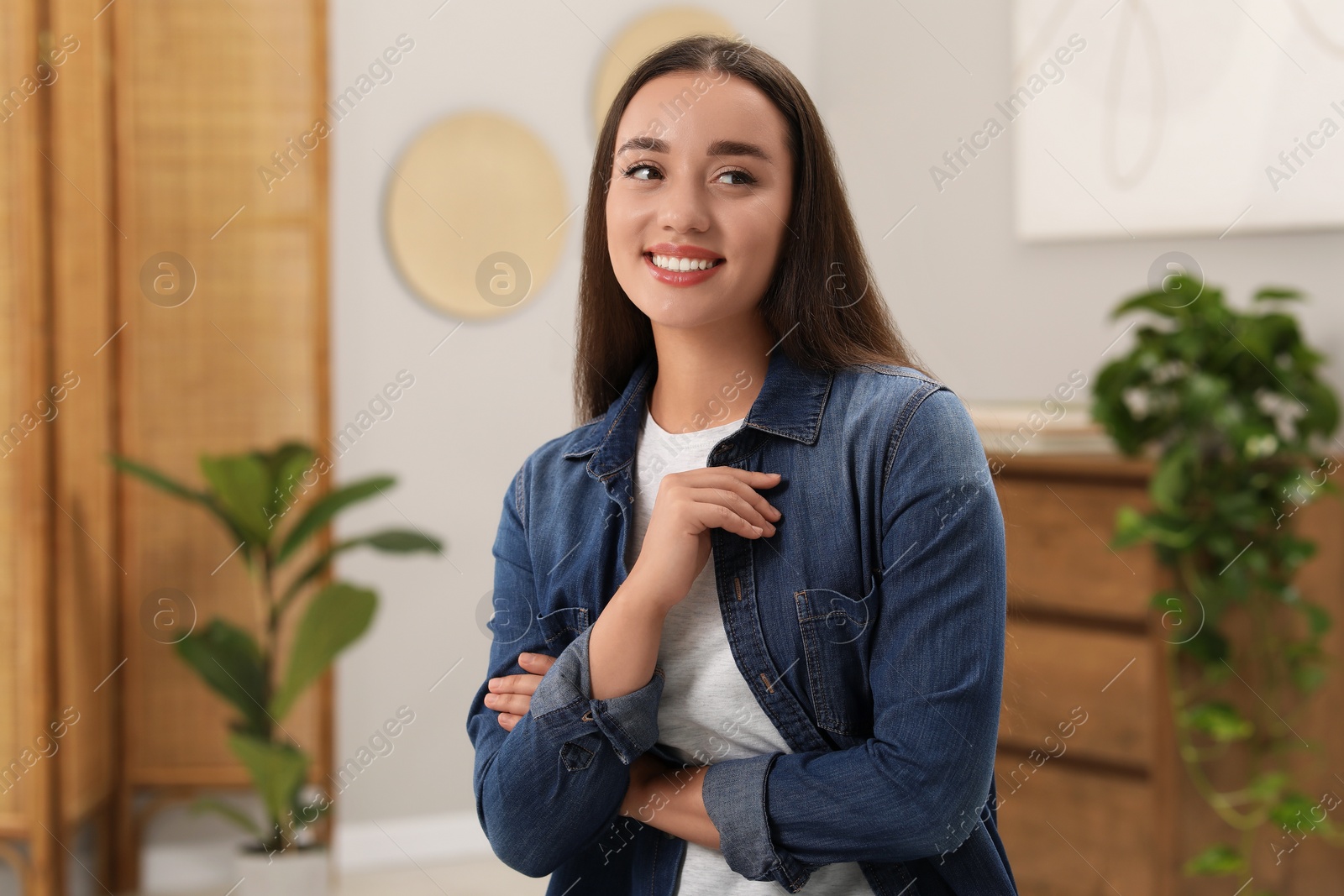 Photo of Portrait of beautiful young woman indoors. Attractive lady posing for camera