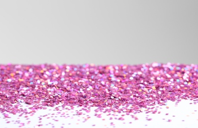 Beautiful shiny paillettes on light background. Space for text