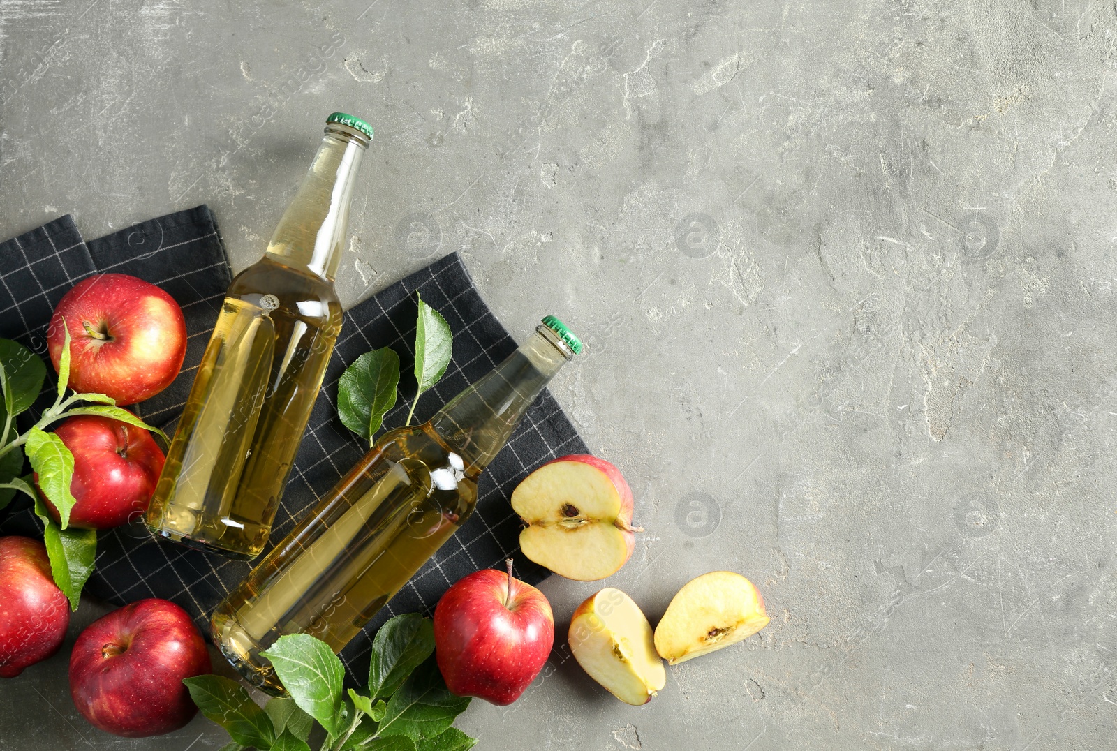 Photo of Flat lay composition with delicious apple cider on gray table, space for text