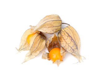 Photo of Many ripe physalis fruits with calyxes isolated on white, top view