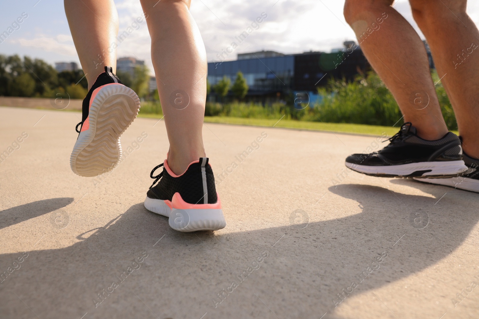 Photo of Healthy lifestyle. Couple running outdoors, closeup view