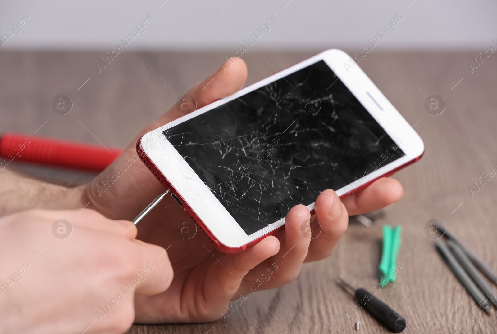 Photo of Technician fixing mobile phone at table, closeup. Device repair service