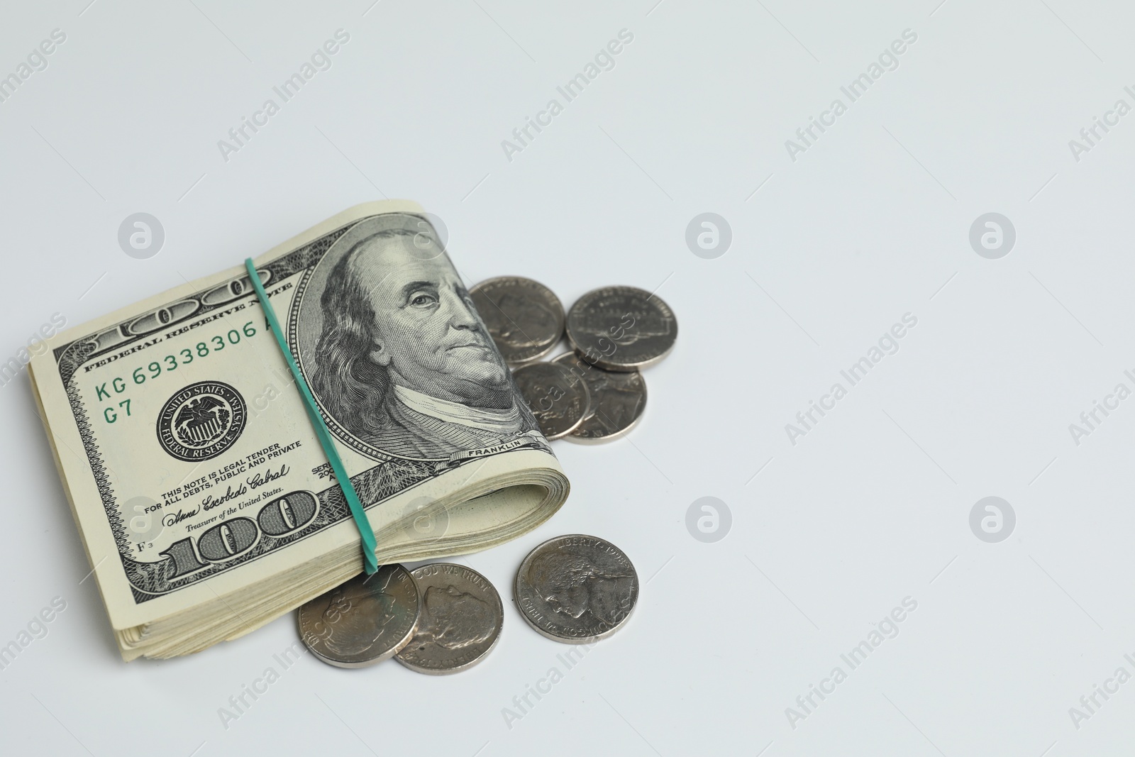 Photo of Money exchange. Dollar banknotes and coins on white background, space for text