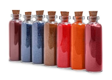 Photo of Glass bottles of different food coloring isolated on white