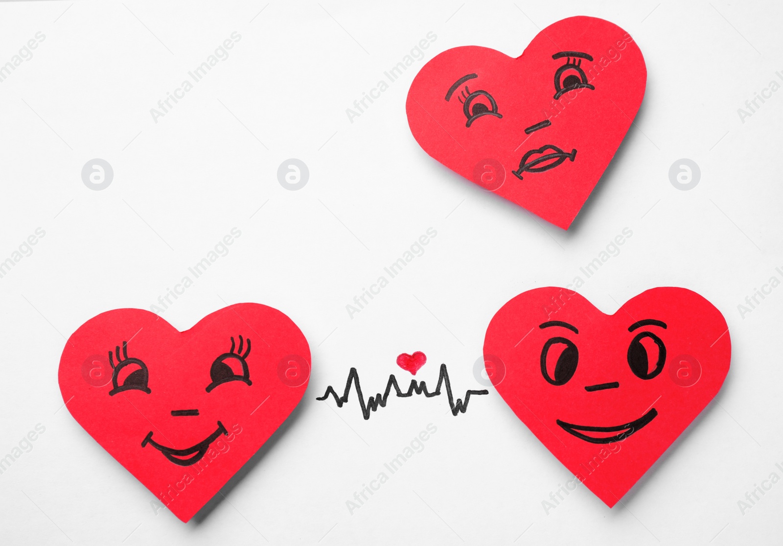 Photo of Paper hearts with drawn faces on white background, top view. Concept of jealousy