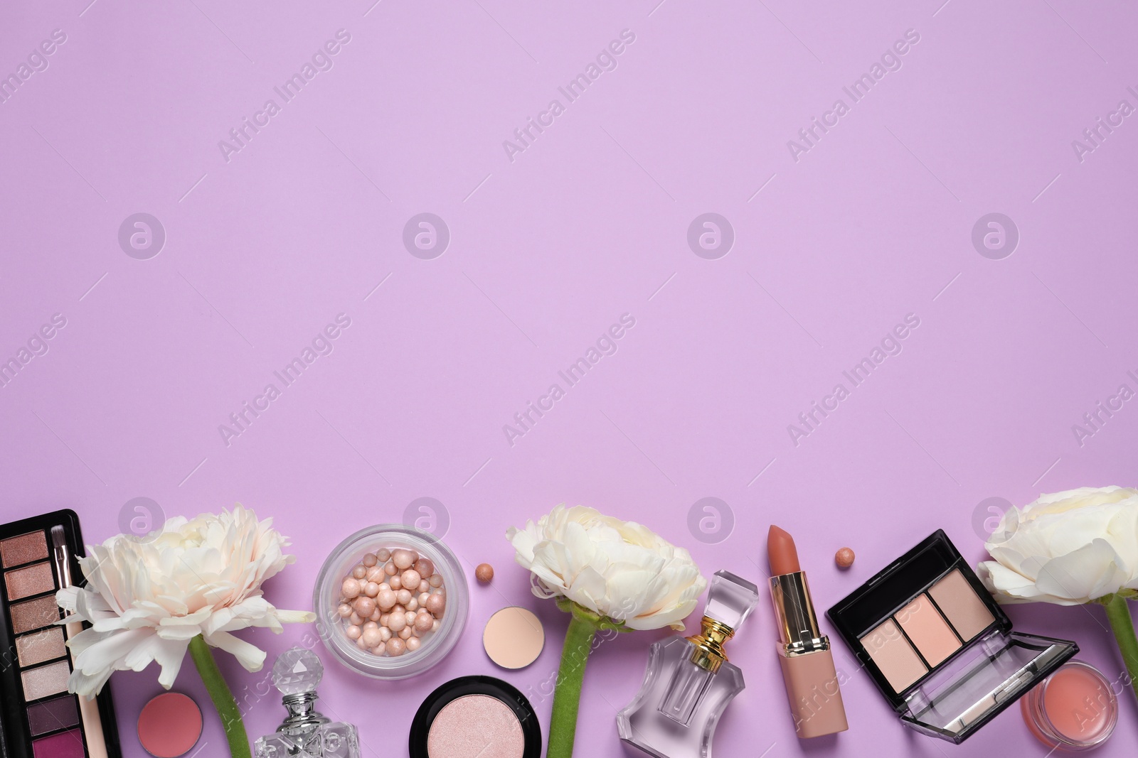 Photo of Flat lay composition with different makeup products and beautiful flowers on violet background, space for text