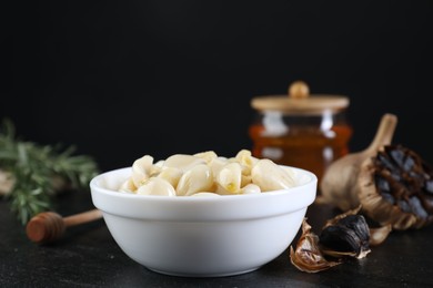 Fresh and fermented black garlic on table