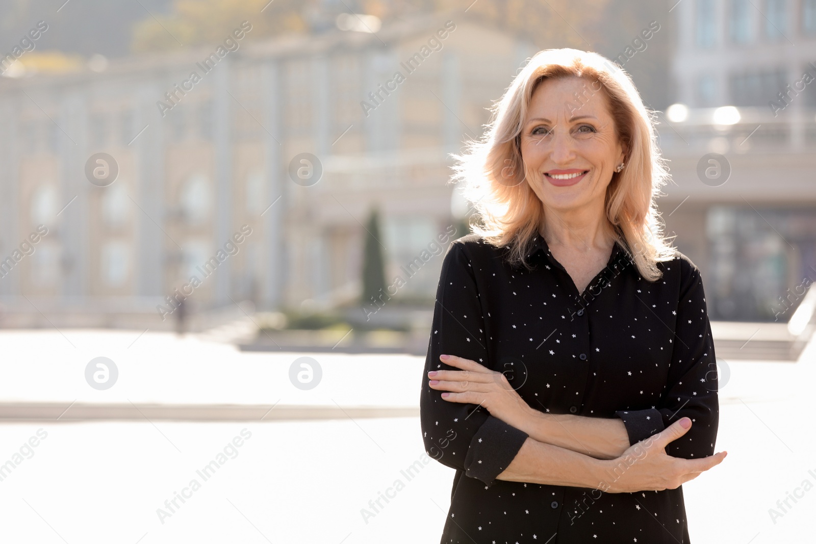 Photo of Portrait of happy mature woman on city street