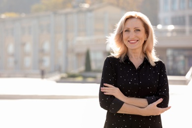 Portrait of happy mature woman on city street