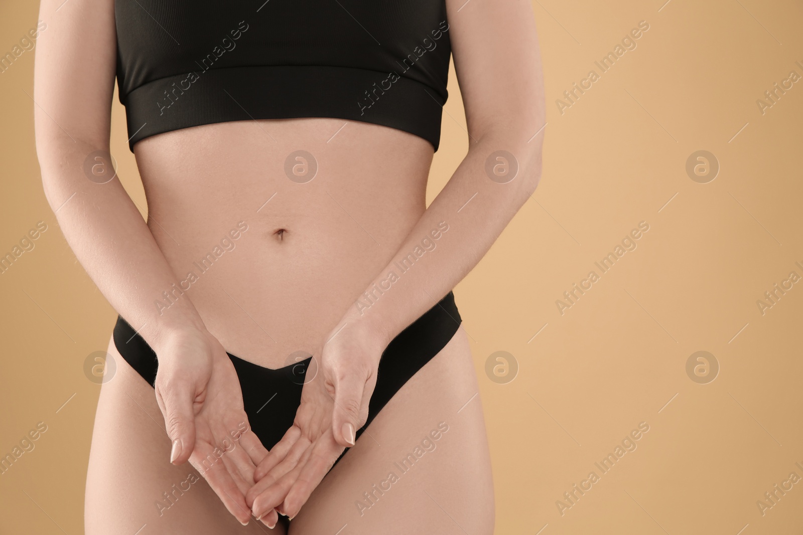 Photo of Gynecology. Woman in underwear on yellow background, closeup. Space for text