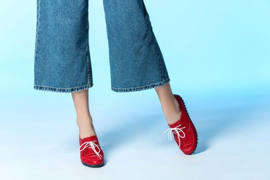 Woman in stylish shoes on color background, closeup. Space for text