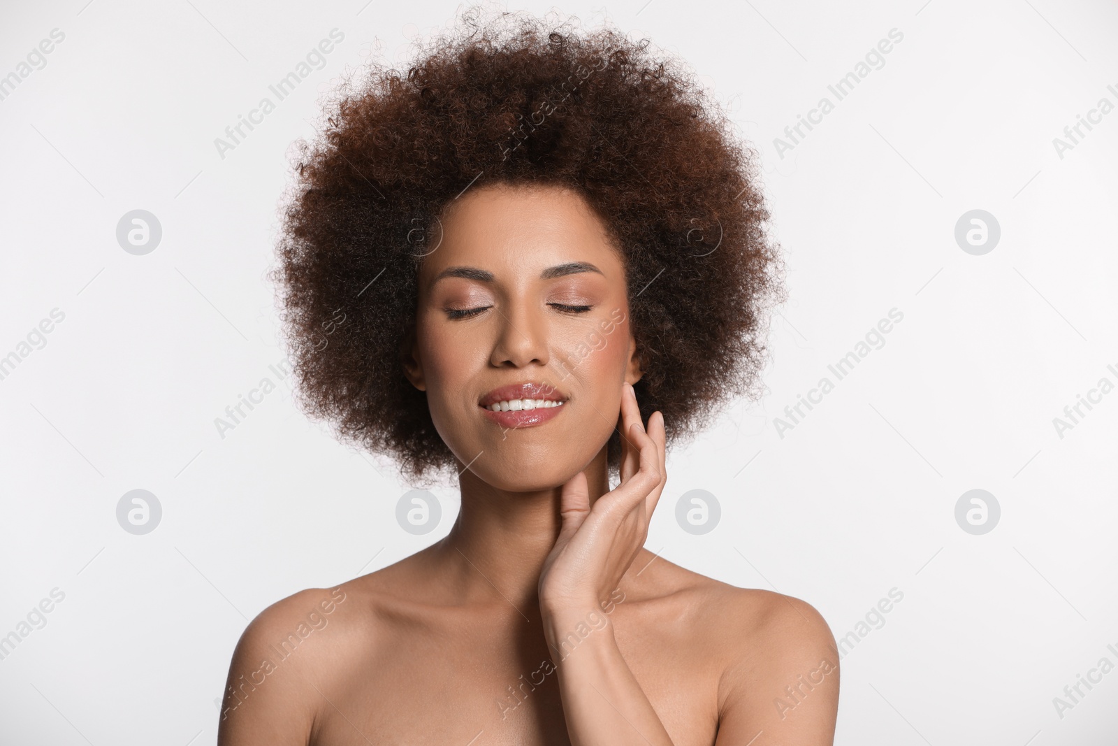 Photo of Portrait of beautiful young woman with glamorous makeup on white background