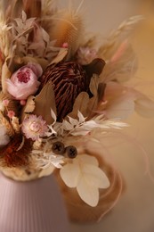 Photo of Bouquet of dry flowers and leaves on blurred background