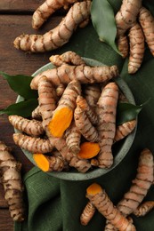 Photo of Fresh turmeric roots on wooden table, flat lay