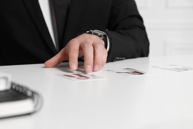 Photo of Human resources manager choosing employee among different applicants at table, closeup