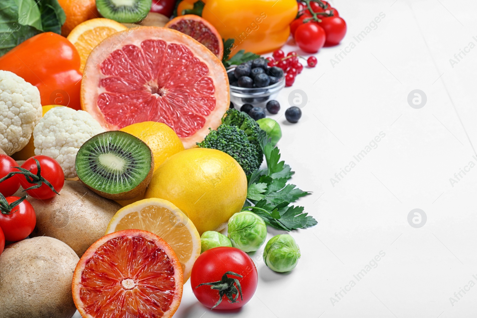 Photo of Different products rich in vitamin C on white background