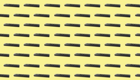Image of Remote controller pattern on light yellow background. Collage design