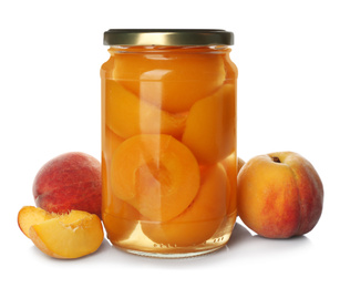 Jar of pickled apricots and fresh fruits on white background