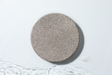 Photo of Presentation for product. Stone podium in water on white background, top view