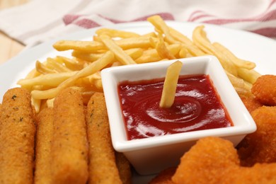 Tasty ketchup, fries and cheese sticks on plate, closeup