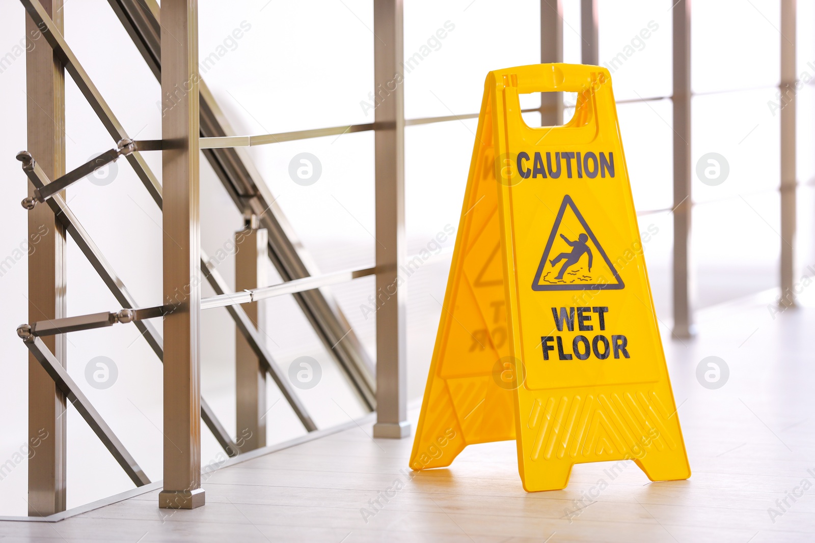 Photo of Safety sign with phrase Caution wet floor, indoors. Cleaning service