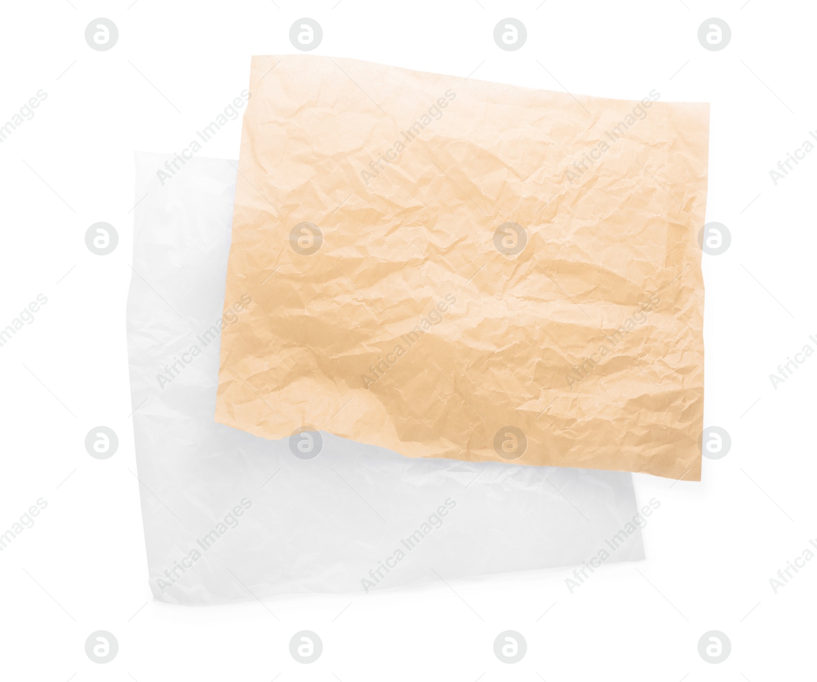 Photo of Sheets of crumpled baking paper on white background, top view