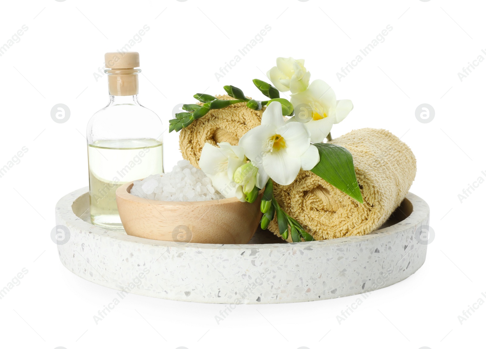 Photo of Spa composition. Towels, essential oil, sea salt and beautiful flowers on white background