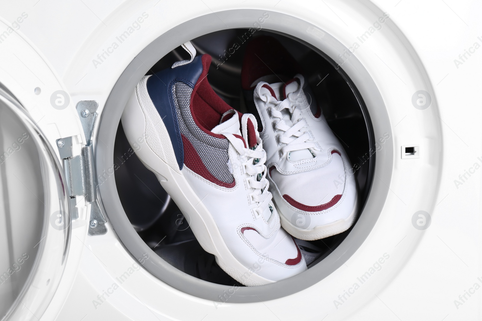 Photo of Clean sport shoes in washing machine drum