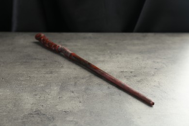 Photo of One magic wand on light grey table