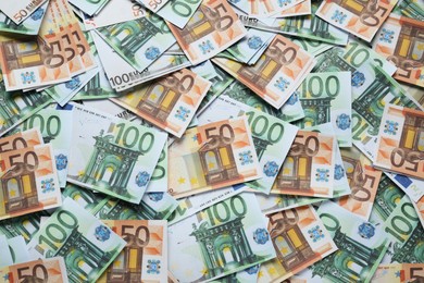 Photo of Different Euro banknotes as background, top view. Money exchange