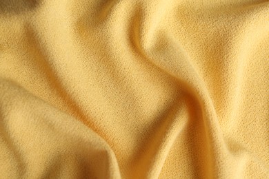 Photo of Texture of beautiful yellow fabric as background, closeup