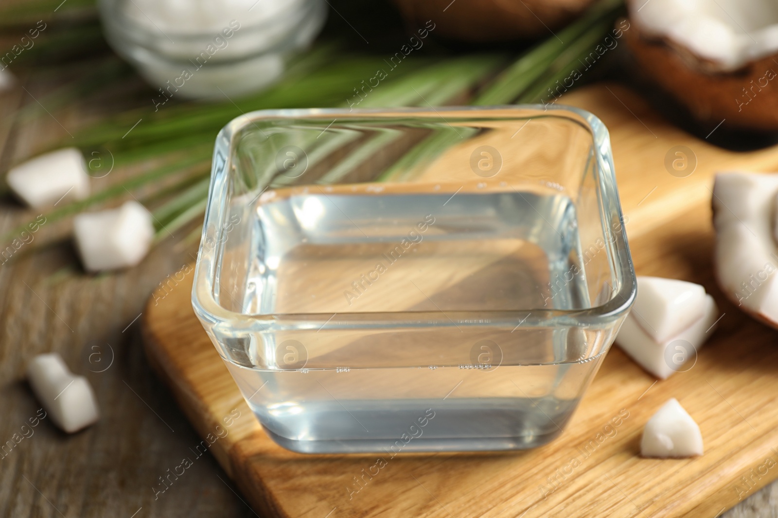 Photo of Coconut oil on wooden board, closeup view