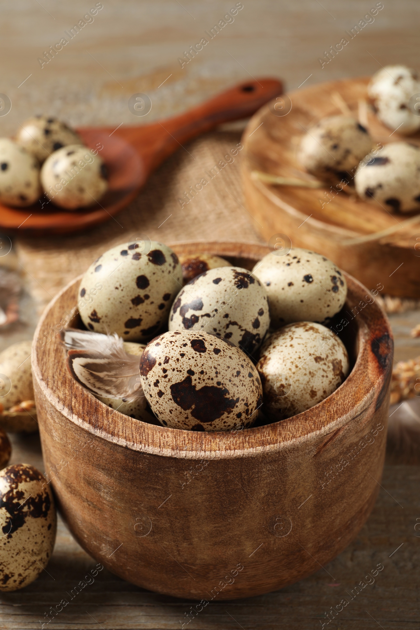 Photo of Bowl with quail eggs on wooden table