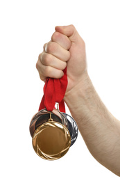 Man holding medals on white background, closeup. Space for design