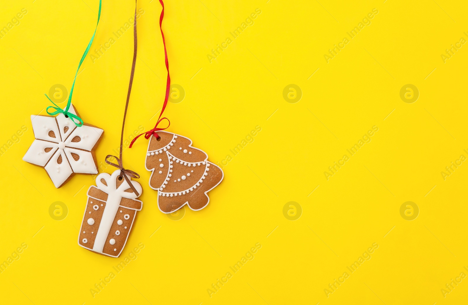 Photo of Different delicious Christmas cookies on yellow background, flat lay. Space for text