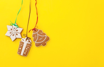Photo of Different delicious Christmas cookies on yellow background, flat lay. Space for text